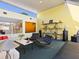 Inviting living room with stylish seating, bright yellow wall, and ample natural light, ideal for entertaining at 2720 Herwald St, Sarasota, FL 34231