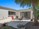 Relaxing patio space with outdoor seating, a table, and lush tropical landscaping creating a serene outdoor space at 2720 Herwald St, Sarasota, FL 34231