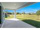 Covered patio overlooking lush green lawn of the expansive backyard at 27407 Deep Creek Blvd, Punta Gorda, FL 33983