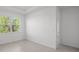 Bright bedroom features large window, neutral color palette, and tiled floors at 27407 Deep Creek Blvd, Punta Gorda, FL 33983