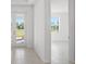 Bright foyer with neutral tile flooring and a view of the neighborhood through the glass front door at 27407 Deep Creek Blvd, Punta Gorda, FL 33983