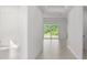 Hallway with tile floors, tray ceiling, and sliding glass doors to the backyard at 27407 Deep Creek Blvd, Punta Gorda, FL 33983
