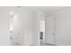 Hallway featuring tile floors, white trim, and a view into the kitchen at 27407 Deep Creek Blvd, Punta Gorda, FL 33983
