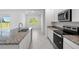 Bright kitchen featuring granite countertops, stainless steel appliances, and modern finishes at 27407 Deep Creek Blvd, Punta Gorda, FL 33983