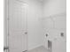 Laundry room with a door, utility connections, and a wire shelf for storage at 27407 Deep Creek Blvd, Punta Gorda, FL 33983