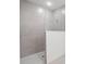 Modern tiled shower stall featuring seamless glass, gray walls, and white shower floor at 27407 Deep Creek Blvd, Punta Gorda, FL 33983