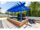 Backyard features a blue pergola over a koi pond and blue potted plants at 2819 130Th E Ave, Parrish, FL 34219