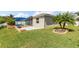 Landscaped backyard with a blue pergola and small palm tree in a garden bed at 2819 130Th E Ave, Parrish, FL 34219