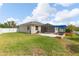 A view of the home's backyard with a screened patio and blue pergola at 2819 130Th E Ave, Parrish, FL 34219