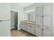 Bathroom with double vanity, granite countertop, and custom cabinets with an adjoining toilet room at 2819 130Th E Ave, Parrish, FL 34219