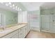 Bathroom featuring double vanity, granite countertop, soaking tub and glass enclosed shower at 2819 130Th E Ave, Parrish, FL 34219