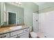 This bathroom features a granite-topped vanity, large mirror, and a shower with white tile at 2819 130Th E Ave, Parrish, FL 34219