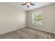 Bedroom features a ceiling fan, carpet flooring, and a bright window with natural light at 2819 130Th E Ave, Parrish, FL 34219