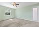Bedroom featuring neutral carpet, light green walls, a ceiling fan, and a door to the exterior at 2819 130Th E Ave, Parrish, FL 34219