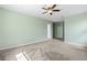 Bedroom featuring neutral carpet, light green walls, and a ceiling fan at 2819 130Th E Ave, Parrish, FL 34219