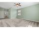 Spacious bedroom with neutral carpet, light green walls, and an ensuite bathroom at 2819 130Th E Ave, Parrish, FL 34219