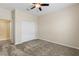 This bedroom features carpet flooring, a ceiling fan, and a closet for storage at 2819 130Th E Ave, Parrish, FL 34219