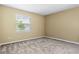 This bedroom features neutral walls, carpet flooring, and a window bringing in natural light at 2819 130Th E Ave, Parrish, FL 34219