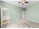 This bedroom features a ceiling fan, carpet flooring, and an ensuite bathroom at 2819 130Th E Ave, Parrish, FL 34219