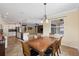 Dining area open to kitchen and living spaces; complete with a chandelier and ample sunlight at 2819 130Th E Ave, Parrish, FL 34219