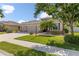 Charming home featuring a well-manicured lawn, a three-car garage, and stone accents at 2819 130Th E Ave, Parrish, FL 34219