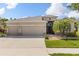 Charming home featuring a well-manicured lawn, a three-car garage, and stone accents at 2819 130Th E Ave, Parrish, FL 34219