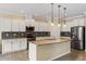 Modern kitchen with white cabinetry, stainless steel appliances, and a granite-topped center island at 2819 130Th E Ave, Parrish, FL 34219