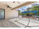This screened in lanai features tile flooring, ceiling fans, and a view of the outdoor pergola at 2819 130Th E Ave, Parrish, FL 34219