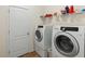 Laundry room features a white washer and dryer with a white door at 2819 130Th E Ave, Parrish, FL 34219