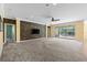 Open living room with stone accent wall, sliding doors to the pool area, and neutral carpet at 2819 130Th E Ave, Parrish, FL 34219