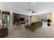 Open-concept living room with stone accent wall, modern furnishings, neutral carpet, and sliding doors to the lanai at 2819 130Th E Ave, Parrish, FL 34219