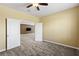 Office featuring neutral carpet, a ceiling fan, and an adjoining stone accent wall at 2819 130Th E Ave, Parrish, FL 34219