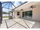 Spacious screened patio with tile flooring, ceiling fans, and sliding glass doors at 2819 130Th E Ave, Parrish, FL 34219