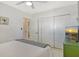 Comfortable bedroom with large closet and a beach-themed TV, and light neutral color scheme at 314 28Th W St, Bradenton, FL 34205