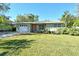 Charming single-story home with a well-maintained lawn, inviting curb appeal, and mature landscaping at 314 28Th W St, Bradenton, FL 34205