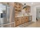 Updated kitchen features stainless steel refrigerator, tile backsplash, and pendant lighting at 314 28Th W St, Bradenton, FL 34205