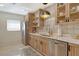 Bright kitchen with stainless steel appliances and custom wood cabinets, and updated hardware at 314 28Th W St, Bradenton, FL 34205