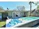 Backyard showcasing a large above-ground pool and hot tub, perfect for outdoor relaxation and entertainment at 314 28Th W St, Bradenton, FL 34205