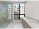 Bright bathroom with marble-tiled shower and modern double sink at 33 S Palm # 1103, Sarasota, FL 34236