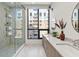 Bathroom with dual sinks, shower, and large window at 33 S Palm # 1103, Sarasota, FL 34236