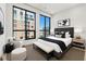 Modern bedroom features large windows, plush bed, and stylish decor at 33 S Palm # 1103, Sarasota, FL 34236