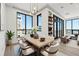 Elegant dining room features modern light fixture, large windows, and an adjacent sitting area at 33 S Palm # 1103, Sarasota, FL 34236