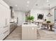 Modern kitchen flows into a dining area, featuring sleek cabinetry, and updated appliances at 33 S Palm # 1103, Sarasota, FL 34236