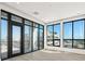 Room filled with natural light, features floor-to-ceiling windows, and a private balcony at 33 S Palm # 1103, Sarasota, FL 34236