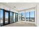 Bright, empty living room, features large windows with exterior views, and balcony access at 33 S Palm # 1103, Sarasota, FL 34236