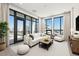 Bright living room with floor-to-ceiling windows and a balcony, showcasing city views at 33 S Palm # 1103, Sarasota, FL 34236