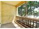Covered balcony overlooking lush greenery and trees, perfect for relaxing outdoors at 3403 Clark Rd # 203, Sarasota, FL 34231