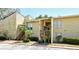 Condo building with exterior stairs, lush landscaping, and a well-maintained facade at 3403 Clark Rd # 203, Sarasota, FL 34231