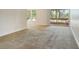 Open living room with carpeting, view of the outdoor balcony, and lots of natural light at 3403 Clark Rd # 203, Sarasota, FL 34231
