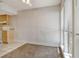Bright living area featuring a carpeted floor, lots of natural light from the windows, and access to the kitchen at 3403 Clark Rd # 203, Sarasota, FL 34231